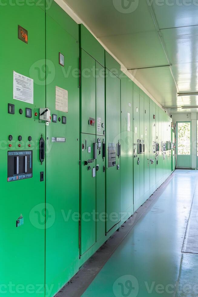 A long row of green electrical panels photo