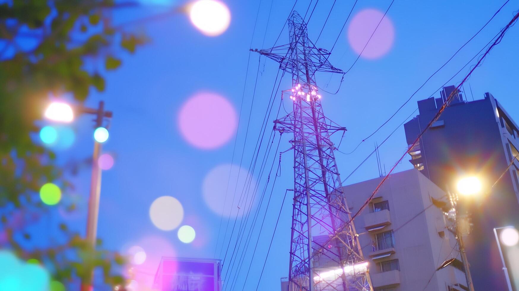 City night, power lines, bokeh lights, building backdrop, urban energy photo