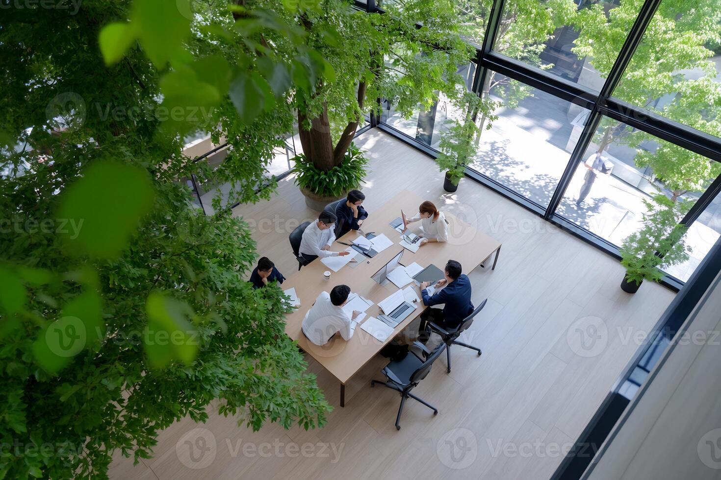 Team meeting, modern office, green atrium, sunlight photo