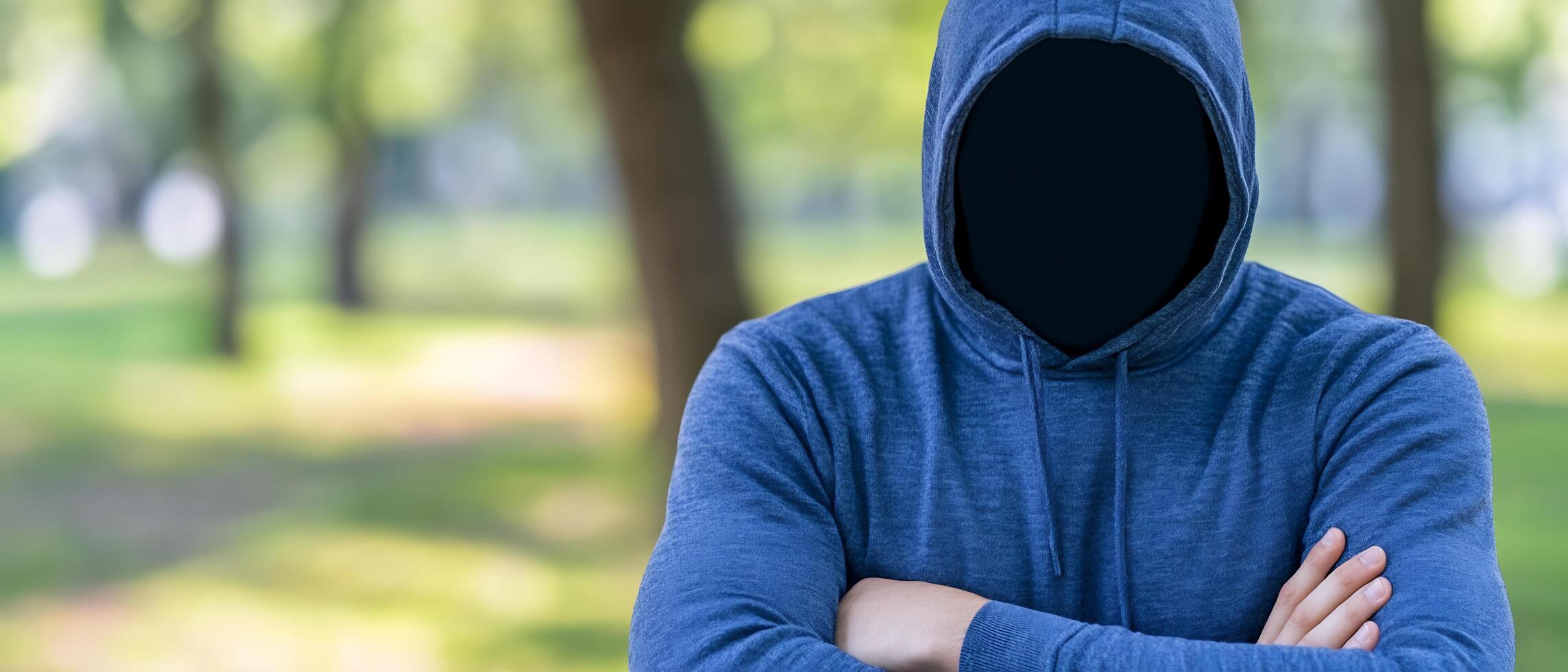 A person wearing a hoodie in the woods photo