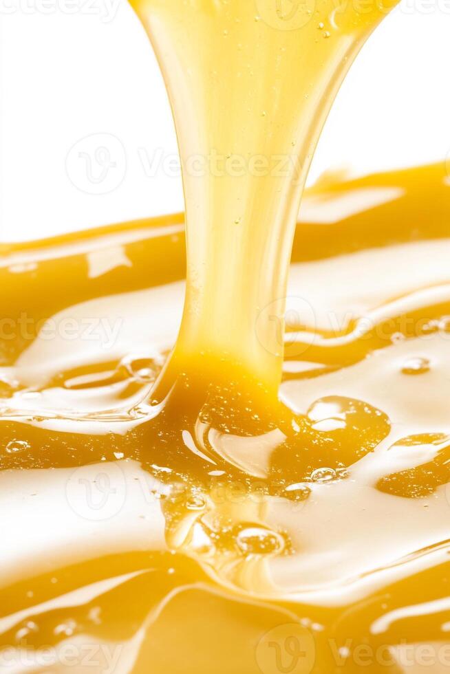 Golden liquid pouring, close-up, white background, texture. Food, drink, advertising use photo