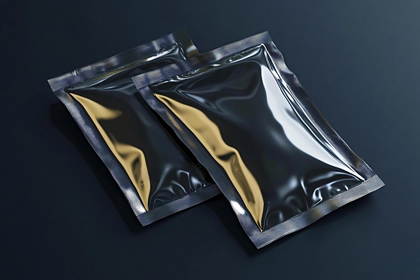 Two glossy metallic sachets lying on dark background photo