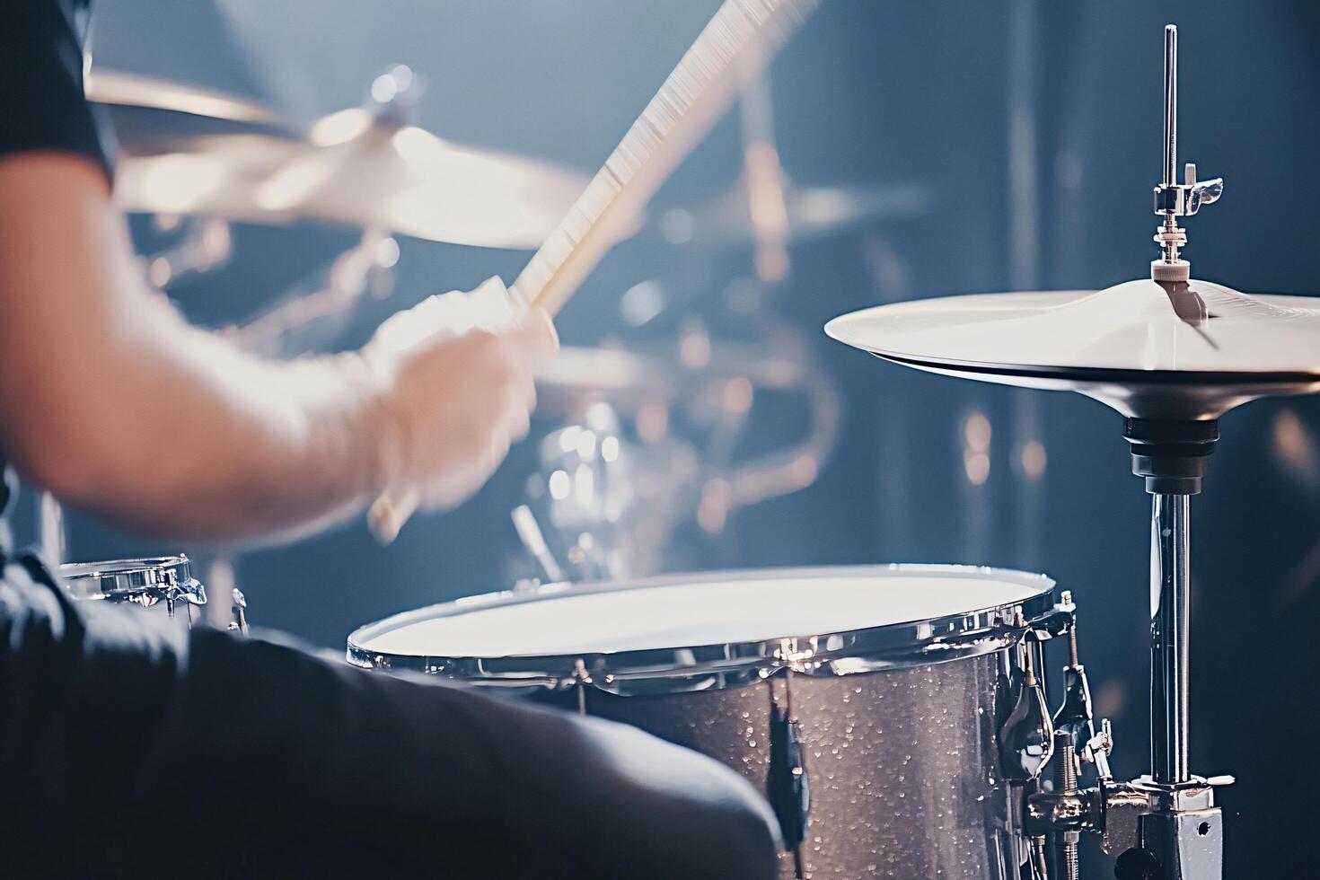 Drummer playing drums during a concert on stage photo