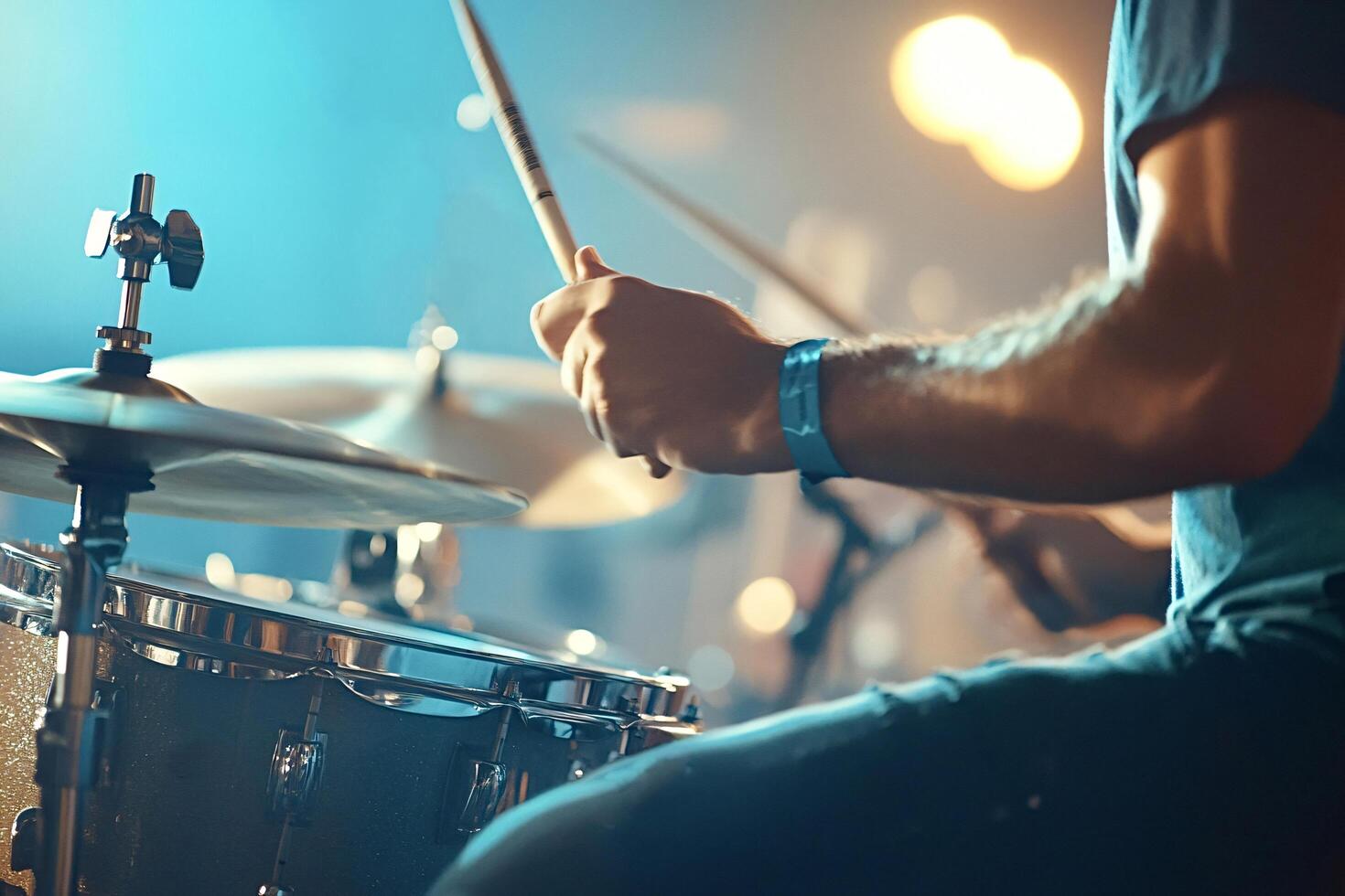 Drummer playing drums during music concert on stage photo
