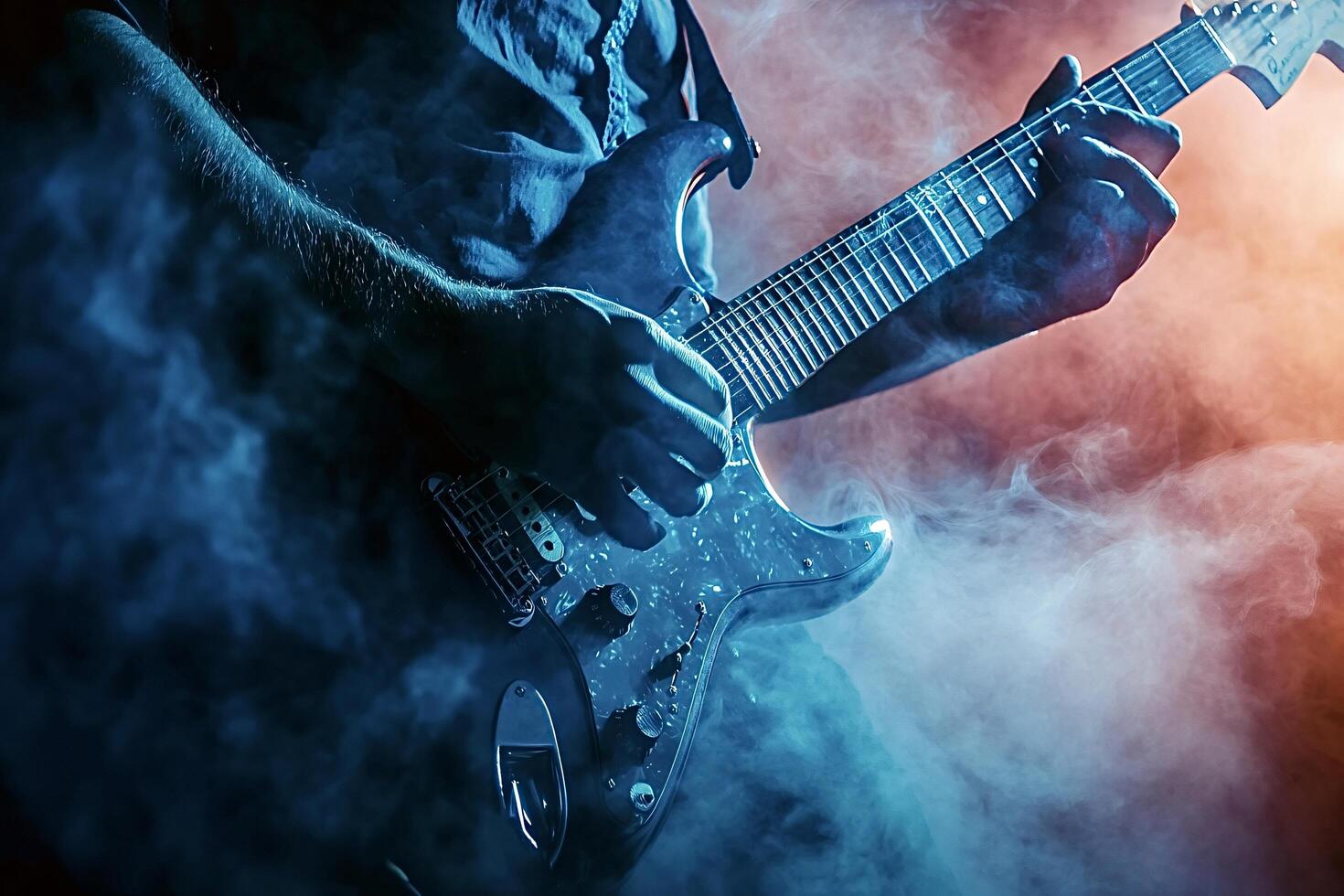 Guitarist playing electric guitar on stage with smoke and lights photo