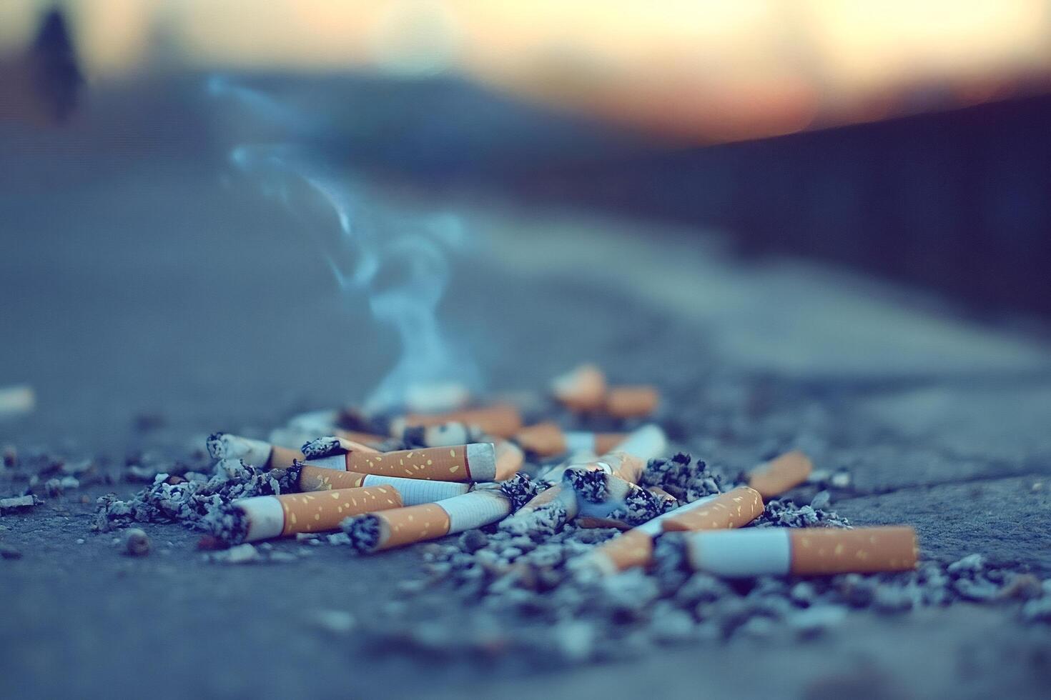 Cigarette butts and ash creating pollution on ground photo