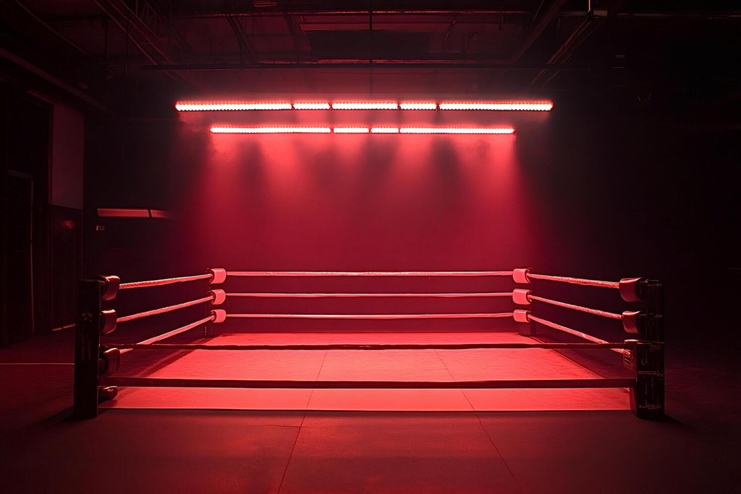Empty boxing ring illuminated by red spotlights in dark arena photo