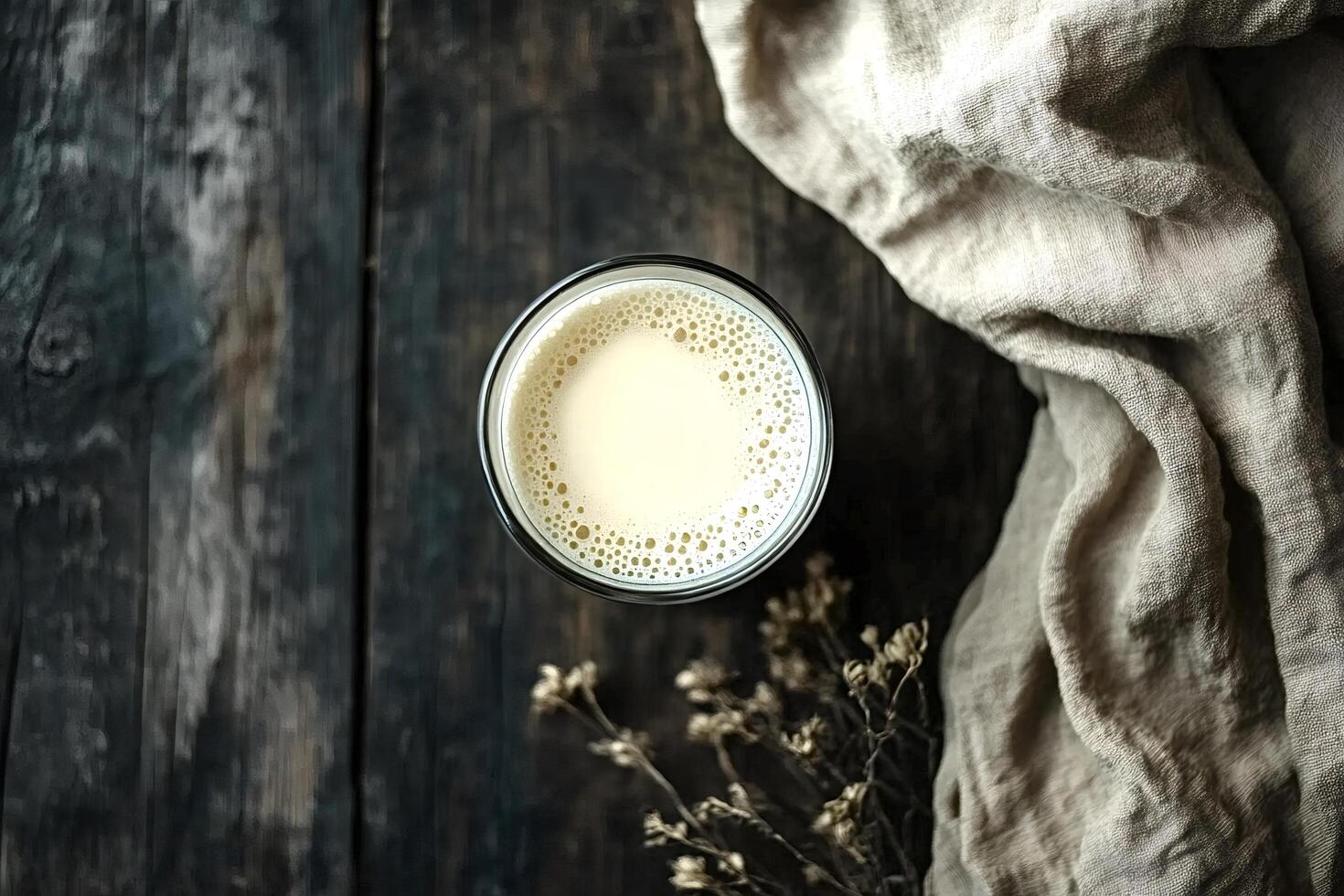 Glass of plant based milk on rustic wooden table with linen cloth photo