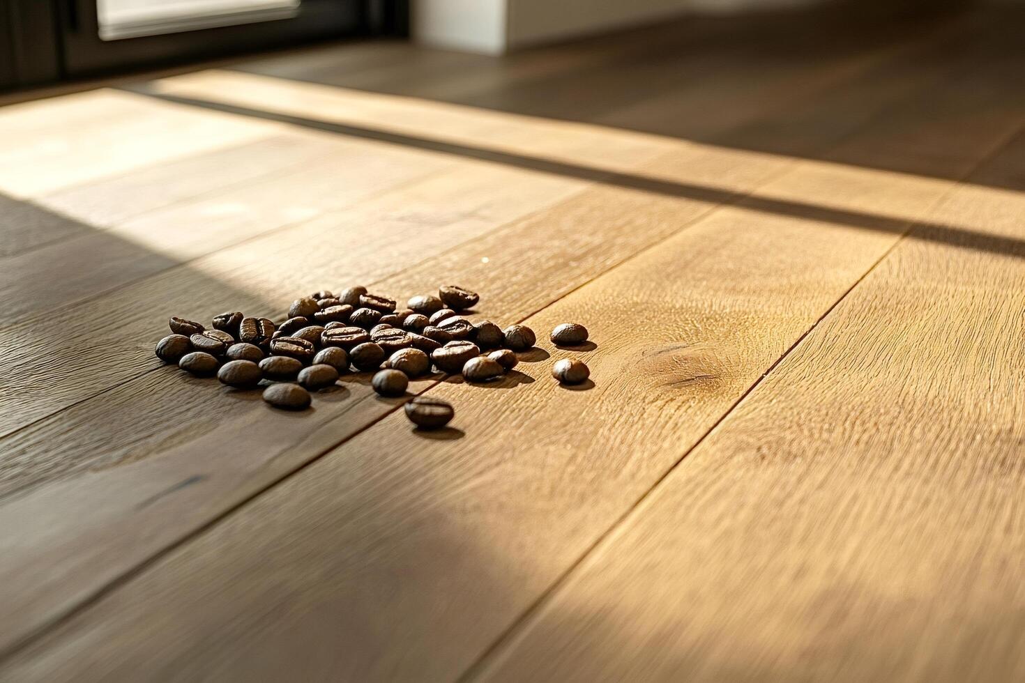 Roasted coffee beans scattered on a wooden table in sunlight photo