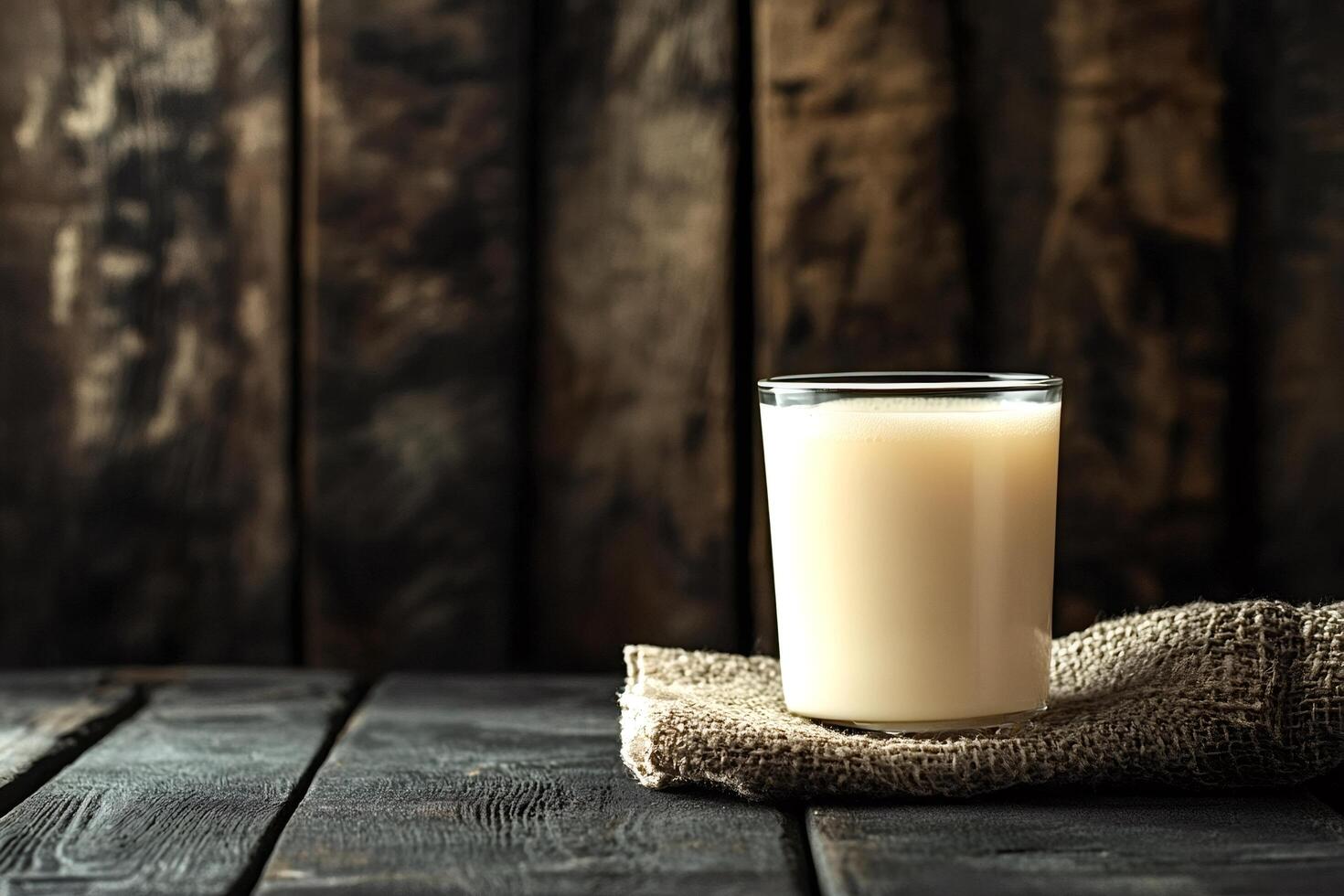 Glass of plant based milk on rustic wooden table photo
