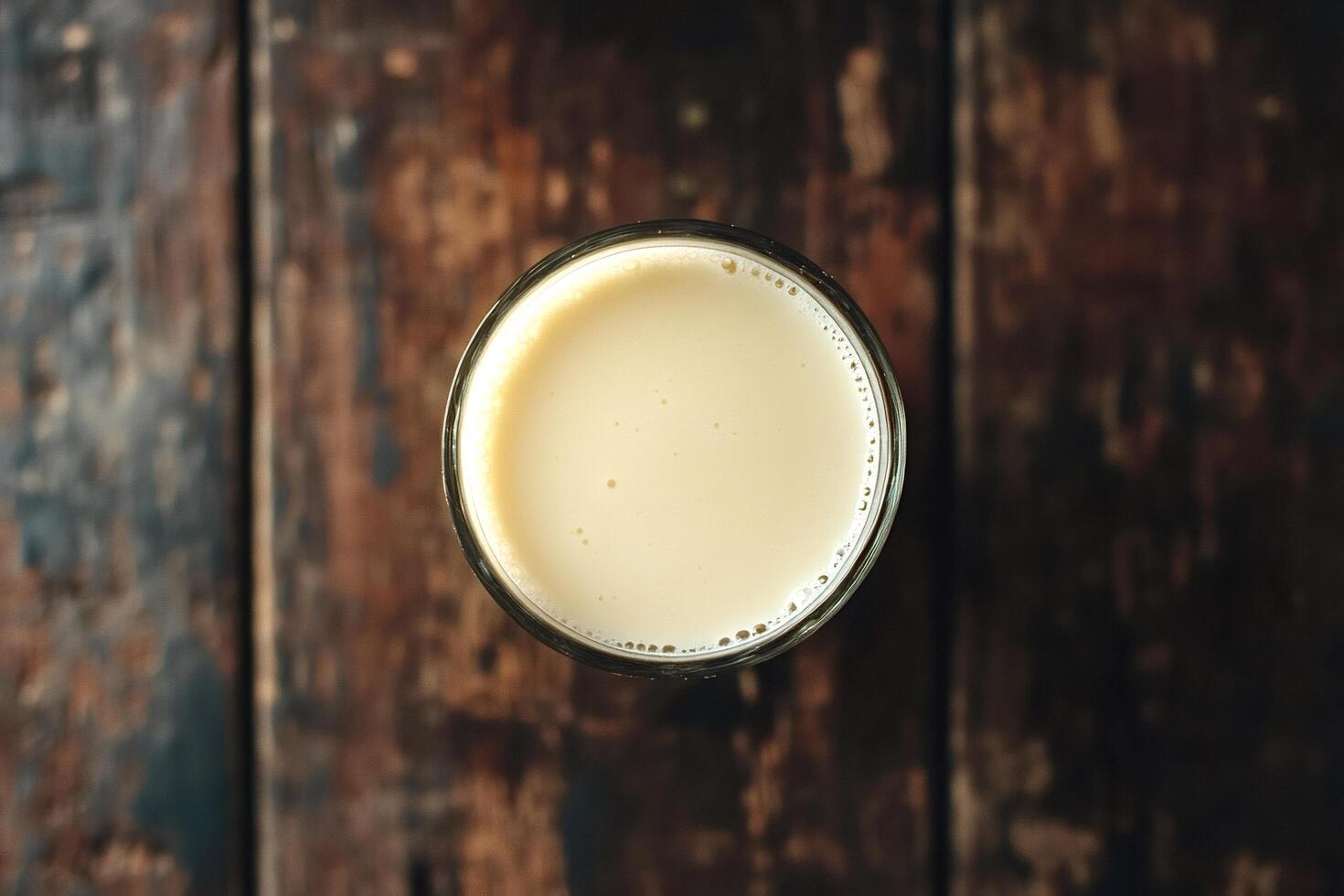 Glass of soy milk resting on rustic wooden table photo