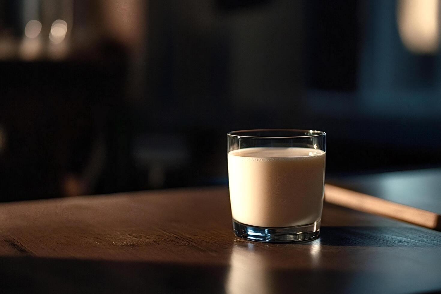 Glass of milk resting on wooden table in cozy kitchen photo