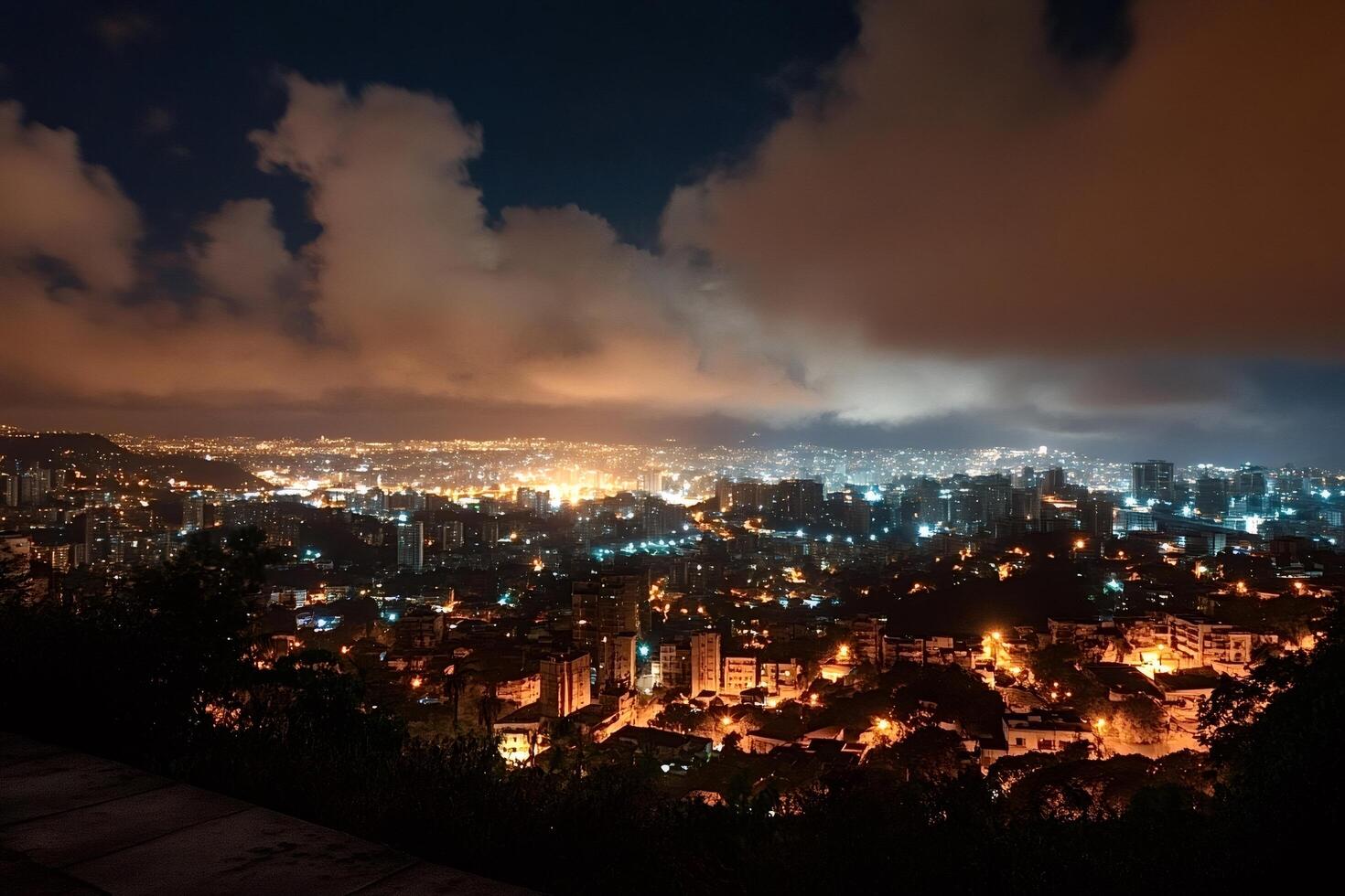 Caracas cityscape illuminating night under cloudy sky in venezuela photo