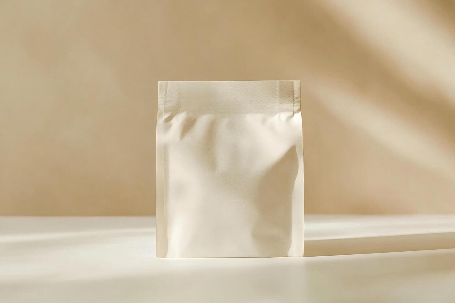 Blank packaging pouch standing on white table with beige background photo