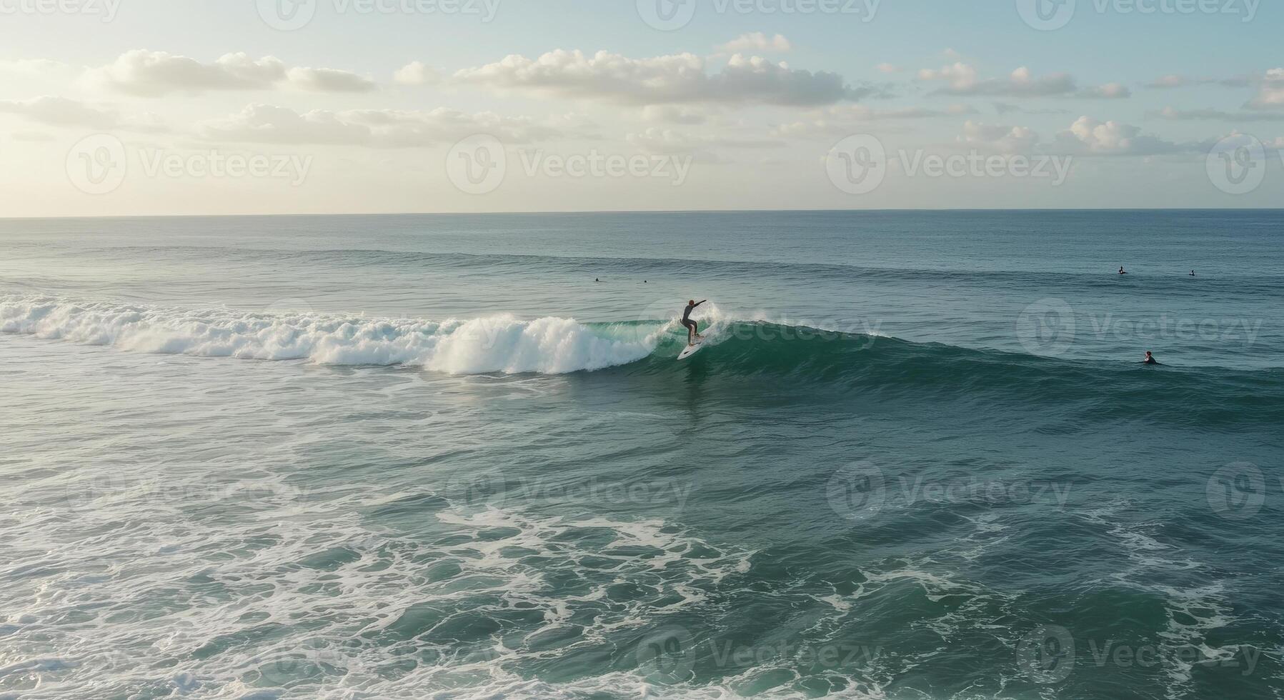 A surfer riding a wave in the ocean photo