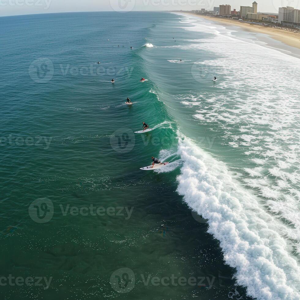 A group of surfers riding the waves of the ocean photo