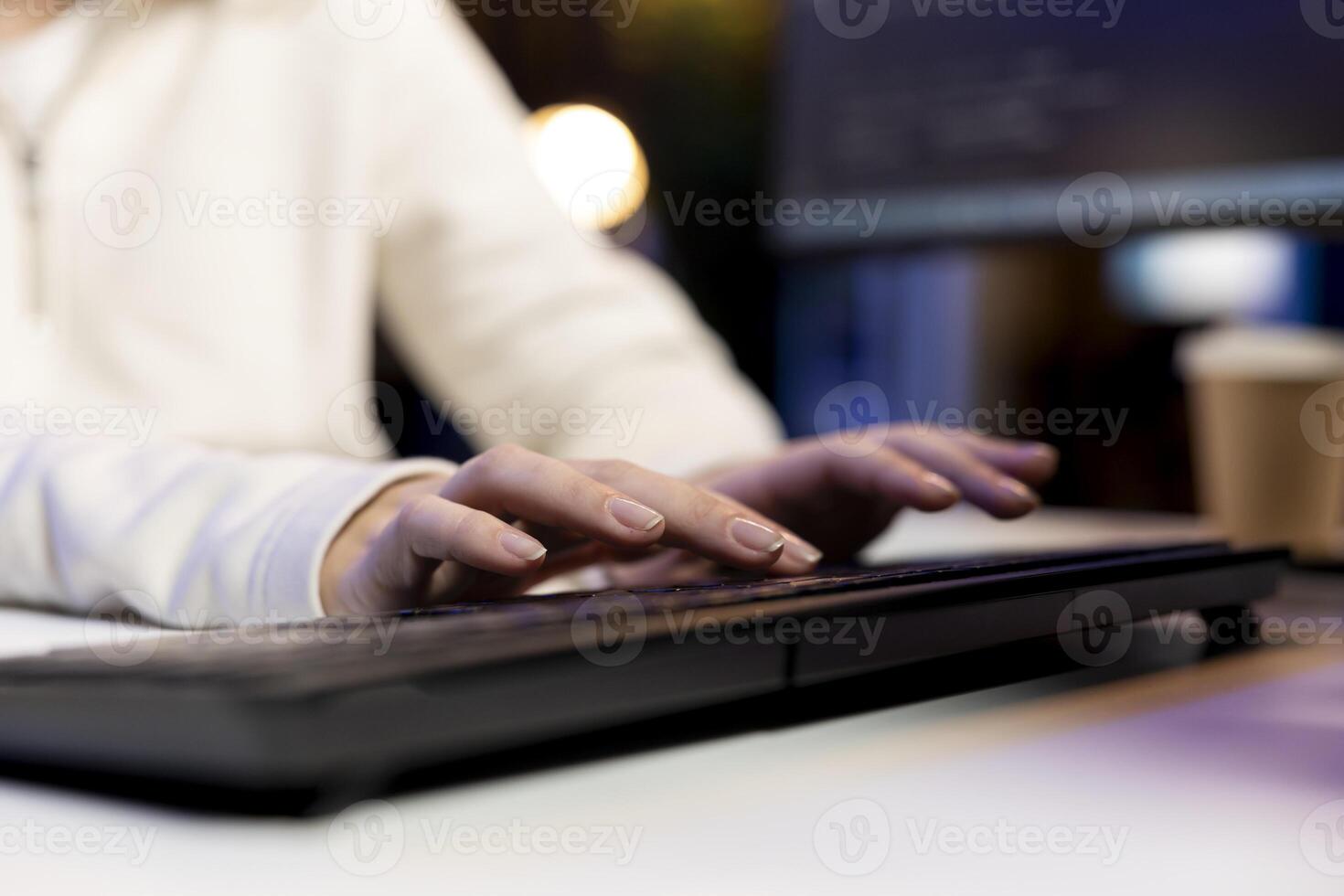 IT operator working from home developing software in JavaScript programming language using PC. Close up shot of system engineer in apartment writing lines of code on computer using keyboard photo
