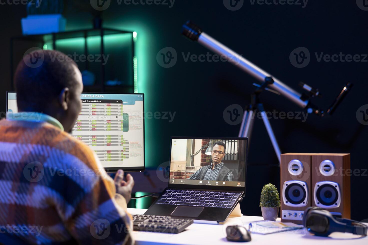 African american male freelancer attends virtual meeting call with clients on laptop, working at home and sharing insight on income statistics. Person looking at screen and listening to call. photo