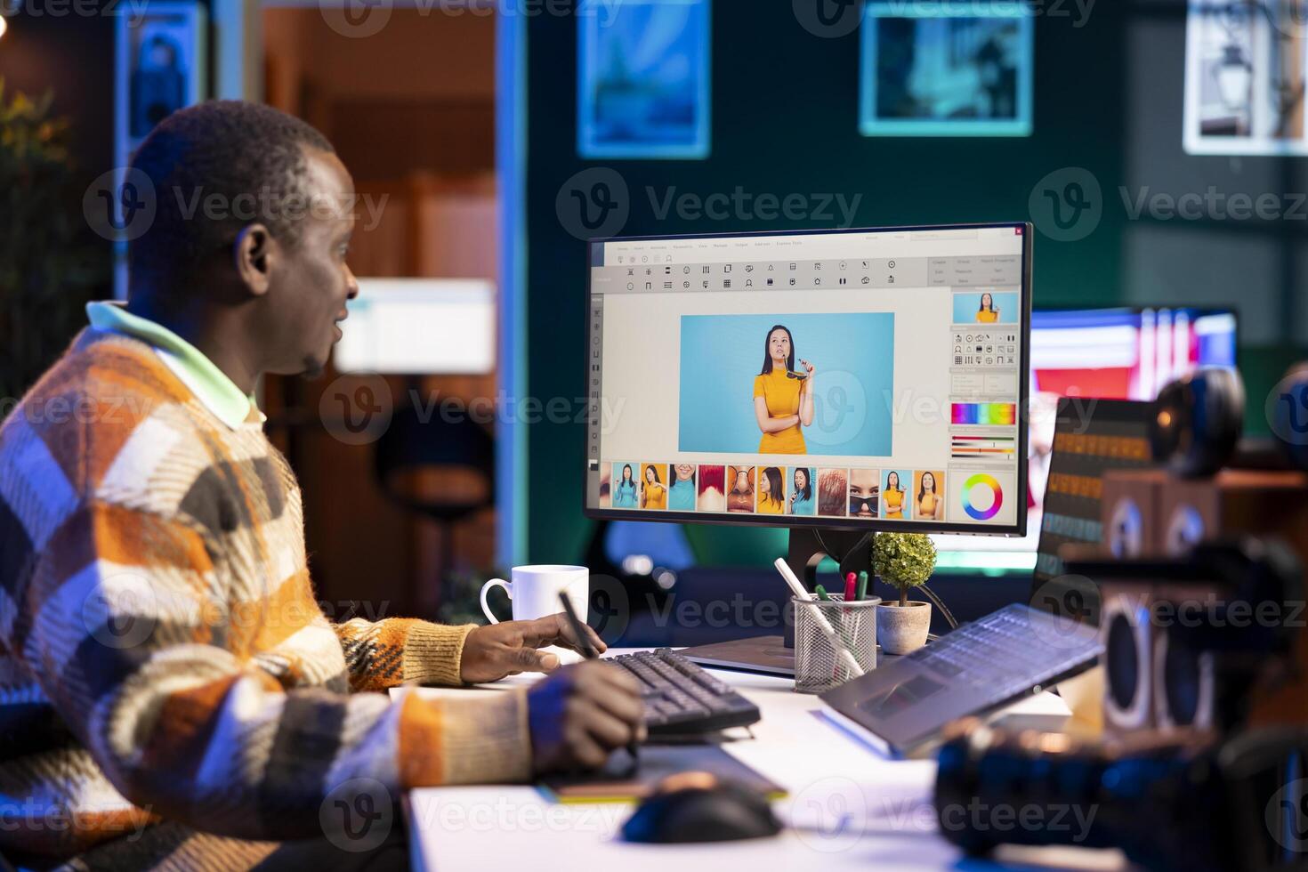 Skilled male designer using editing software on dual monitors in organized modern workspace, symbolizing the future of digital design and remote work. Digital art photo retouching.