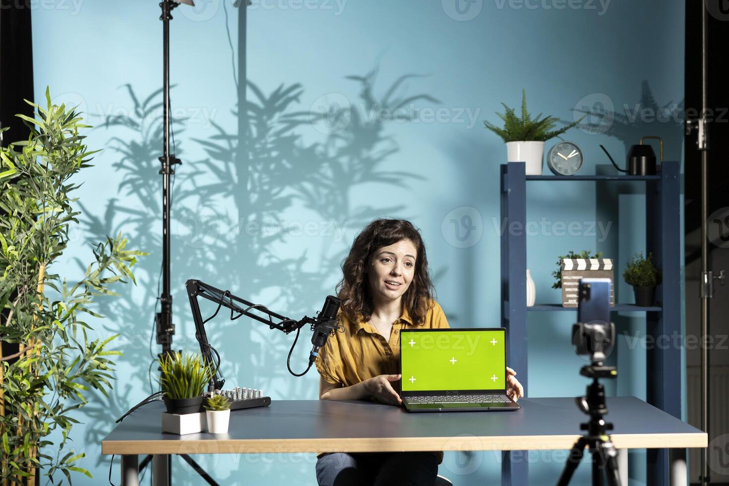 Smiling tech professional assessing isolated screen laptop performance, talking about components used inside. Joyous content creator shooting mockup notebook review for online channel photo