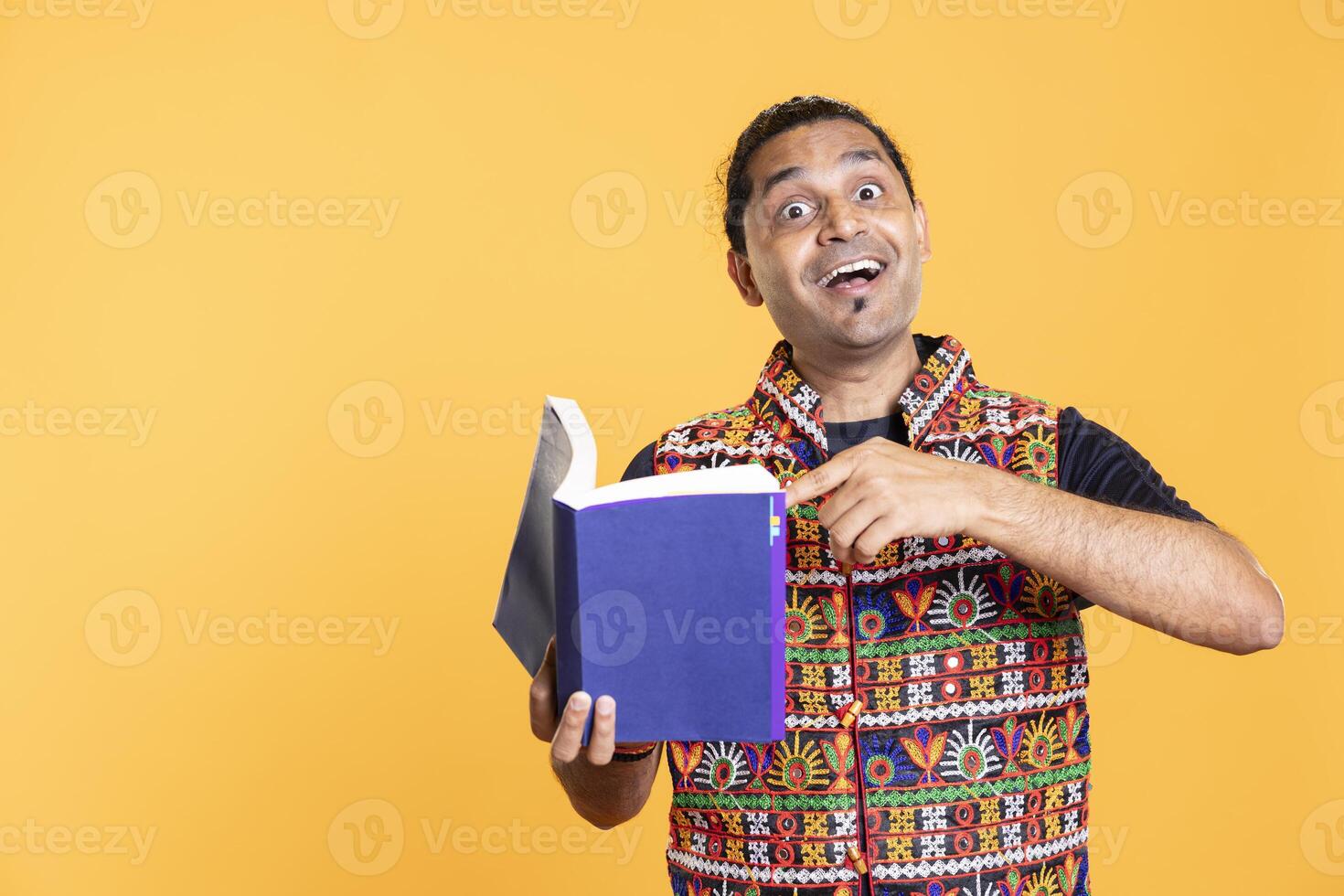 Overjoyed reading lover recommending good book from favorite author, isolated over studio background. Ecstatic person endorsing novel, appreciating thrilling writing style photo