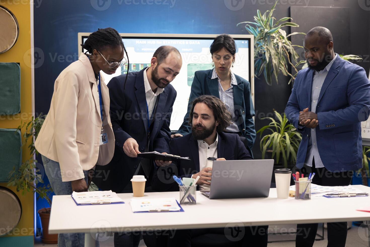 CEO verifies what his employees achieved with the new project, reading infographics and following capital funding increase. Administrator showing satisfaction for his team work progress. photo