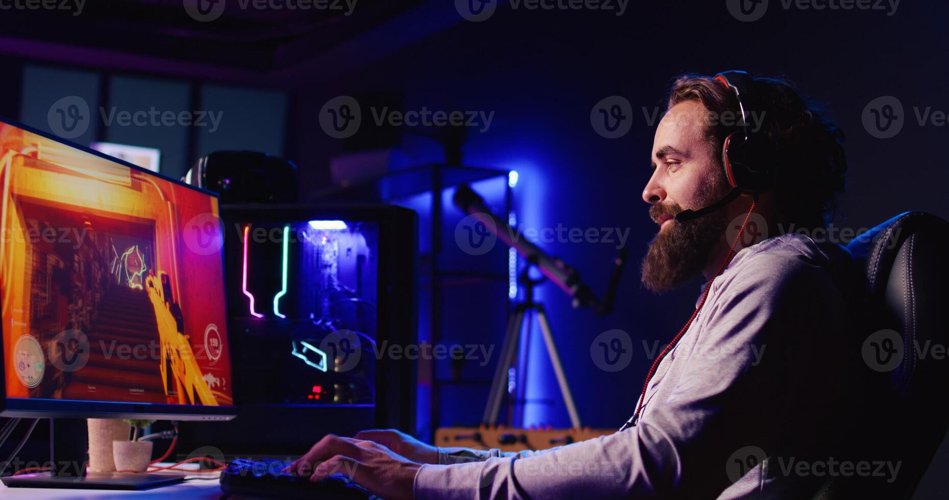 Smiling man reaching final mission in coop FPS videogame, battling flying robots with his online friends. Gamer chats with internet teammates while playing first person shooter game, fighting boss photo