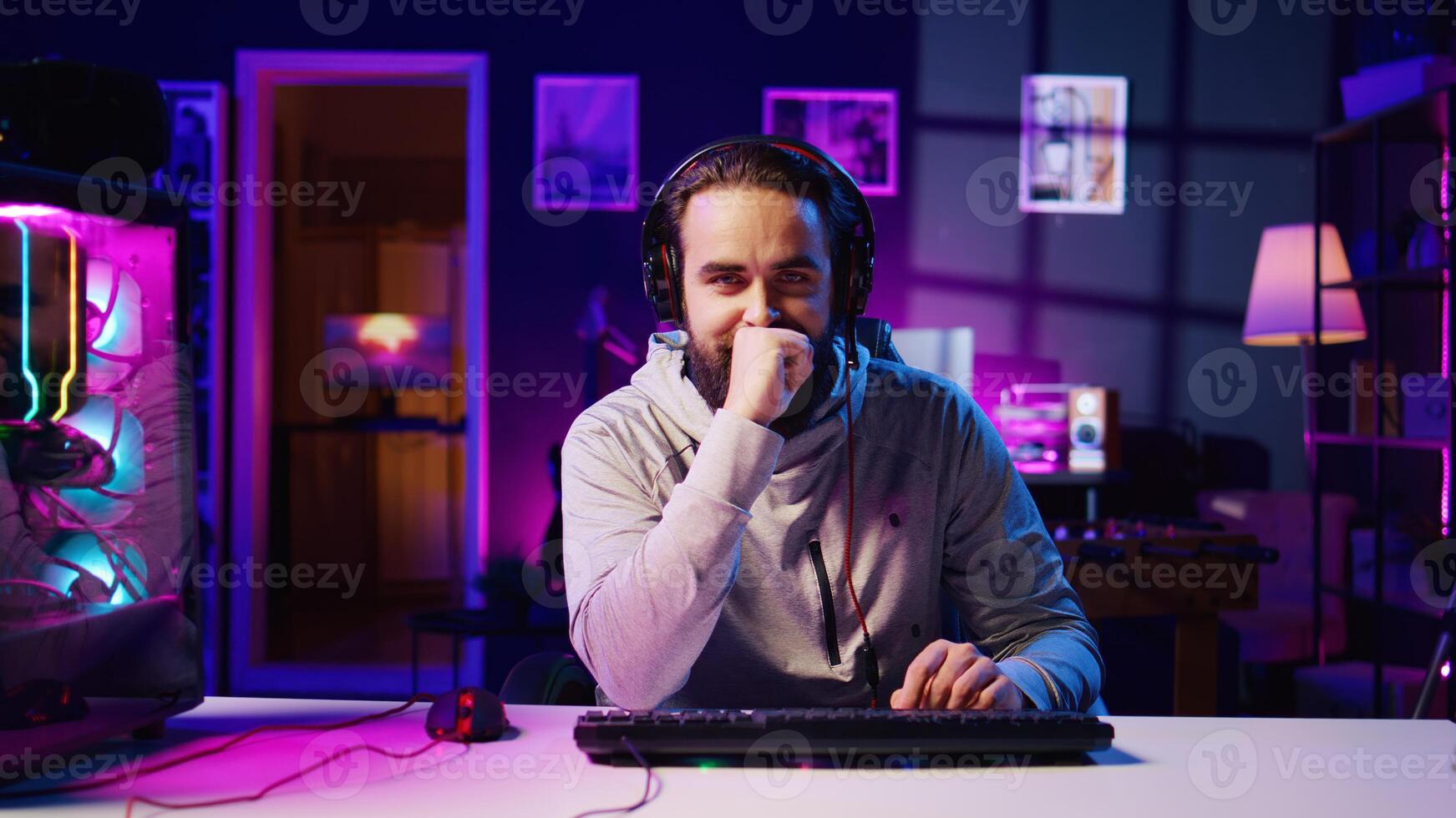 Esports player recording himself playing videogames in front of audience during livestream, providing engaging commentary while battling opponents. Pro gamer participating in gaming competition photo