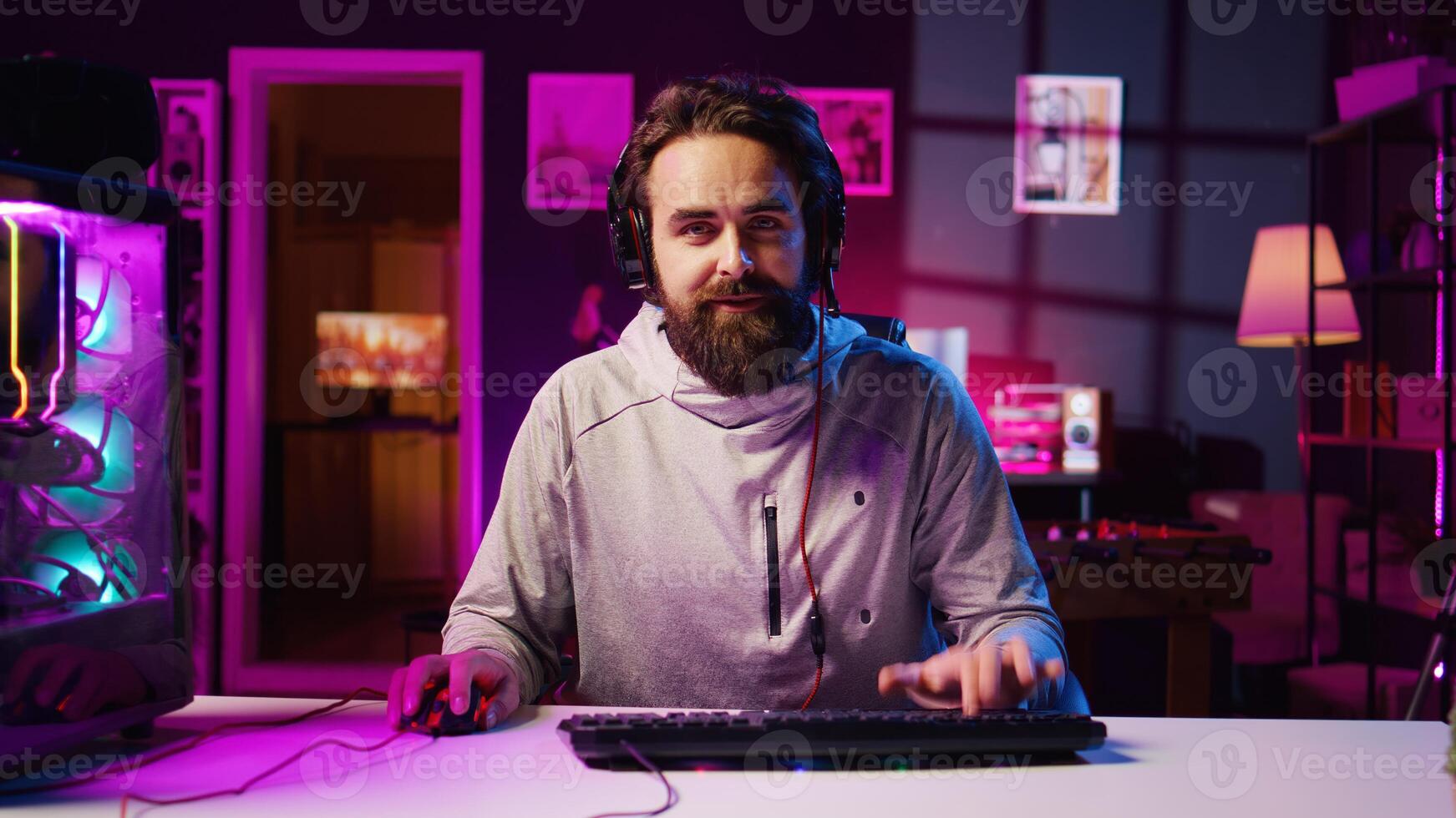 Pro gamer wearing headphones playing game, teaching audience professional esports players skills. Content creator in gaming chair talking with audience, filming tutorial on how to defeat enemies photo