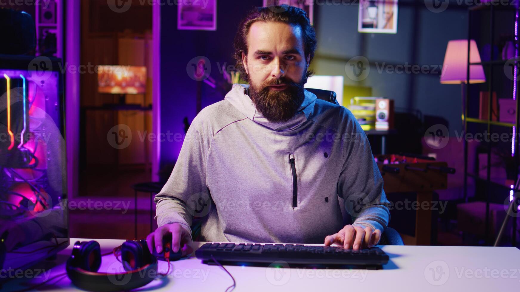Pro gamer playing intense game, teaching audience professional esports players skills. Man in gaming chair talking with audience, filming tutorial in how to defeat enemies photo