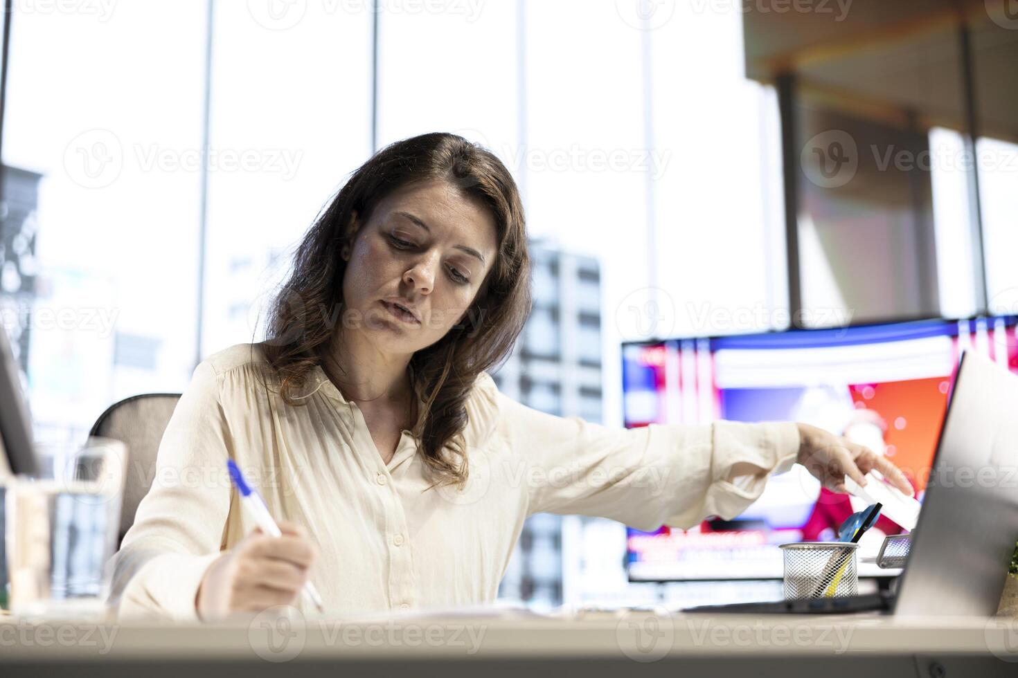 Enterprise director authorizing all work contracts and documents, signing paperwork as CEO with executive power. Solving all her legal obligations in high end modern office, leadership skills. photo