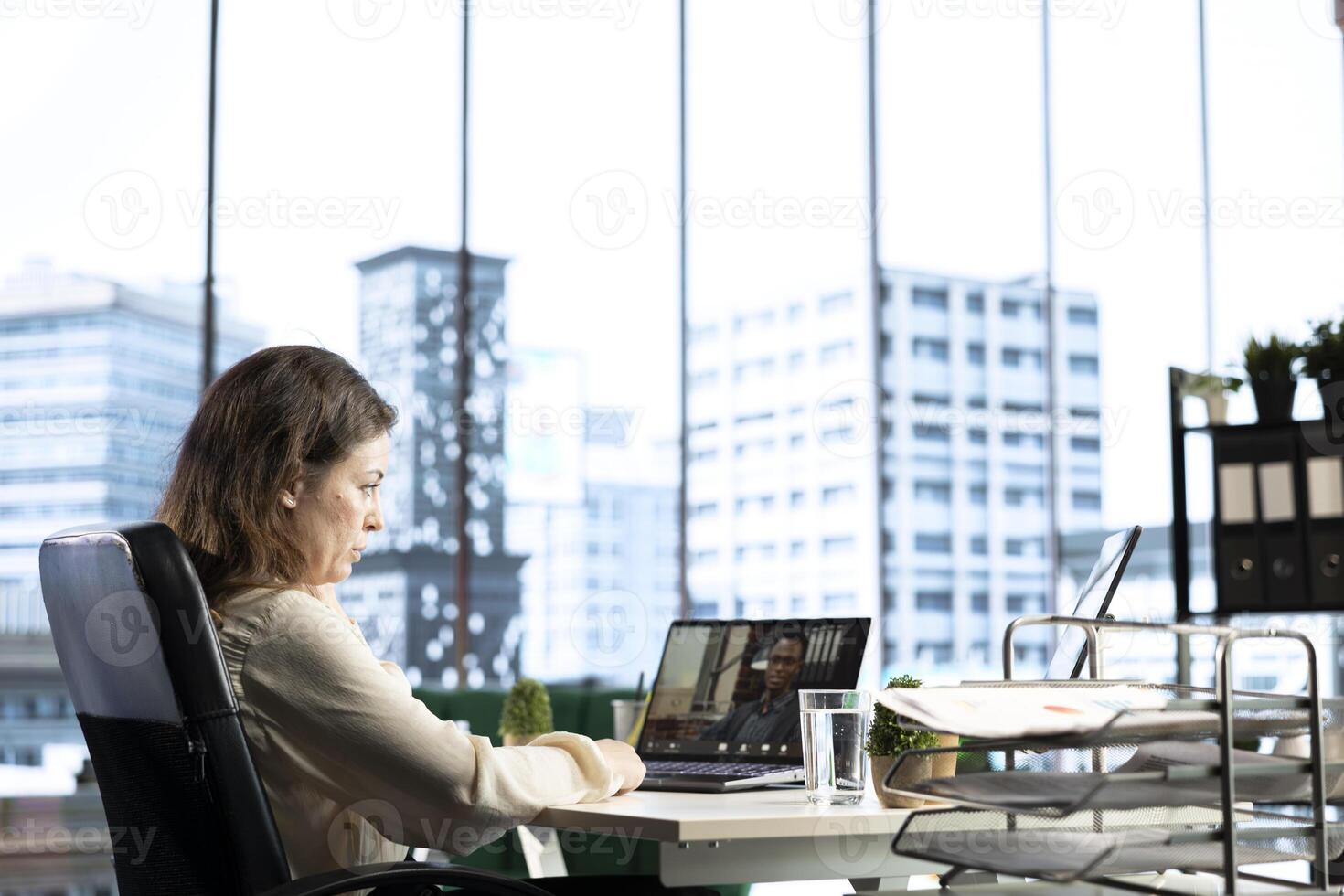 Successful female entrepreneur collaborates with her experts team, focusing on problem solving, decision making and achieving strategic business objectives. Determination and authority. photo