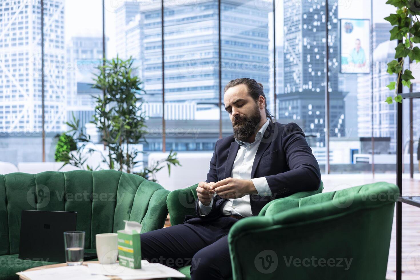 Unwell leader taking a painkiller to ease the pain due to overload and burnout, working in discomfort and under pressure. Worried stressed CEO deals with a headache, overburdened. photo