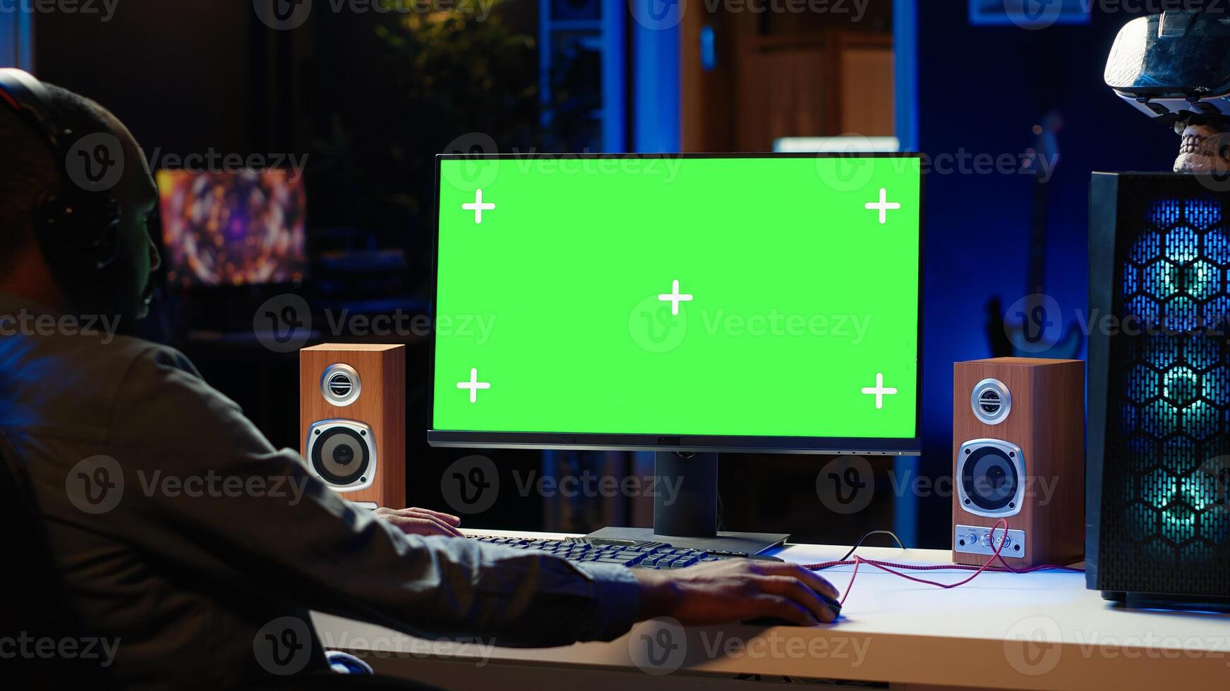 Professional streamer looking at isolated screen monitor, competing in online videogame, streaming live at home. Mockup display used by man playing on PC, using headphones to talk photo