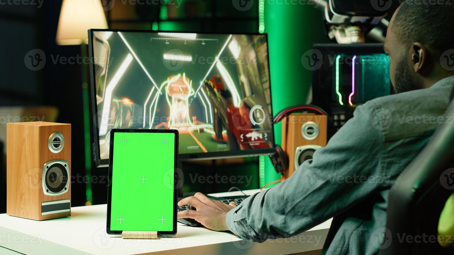 Chroma key tablet next to man playing high FPS singleplayer videogame with spaceship shooting lasers. Green screen device near gamer using crosshair to hit targets in SF game photo
