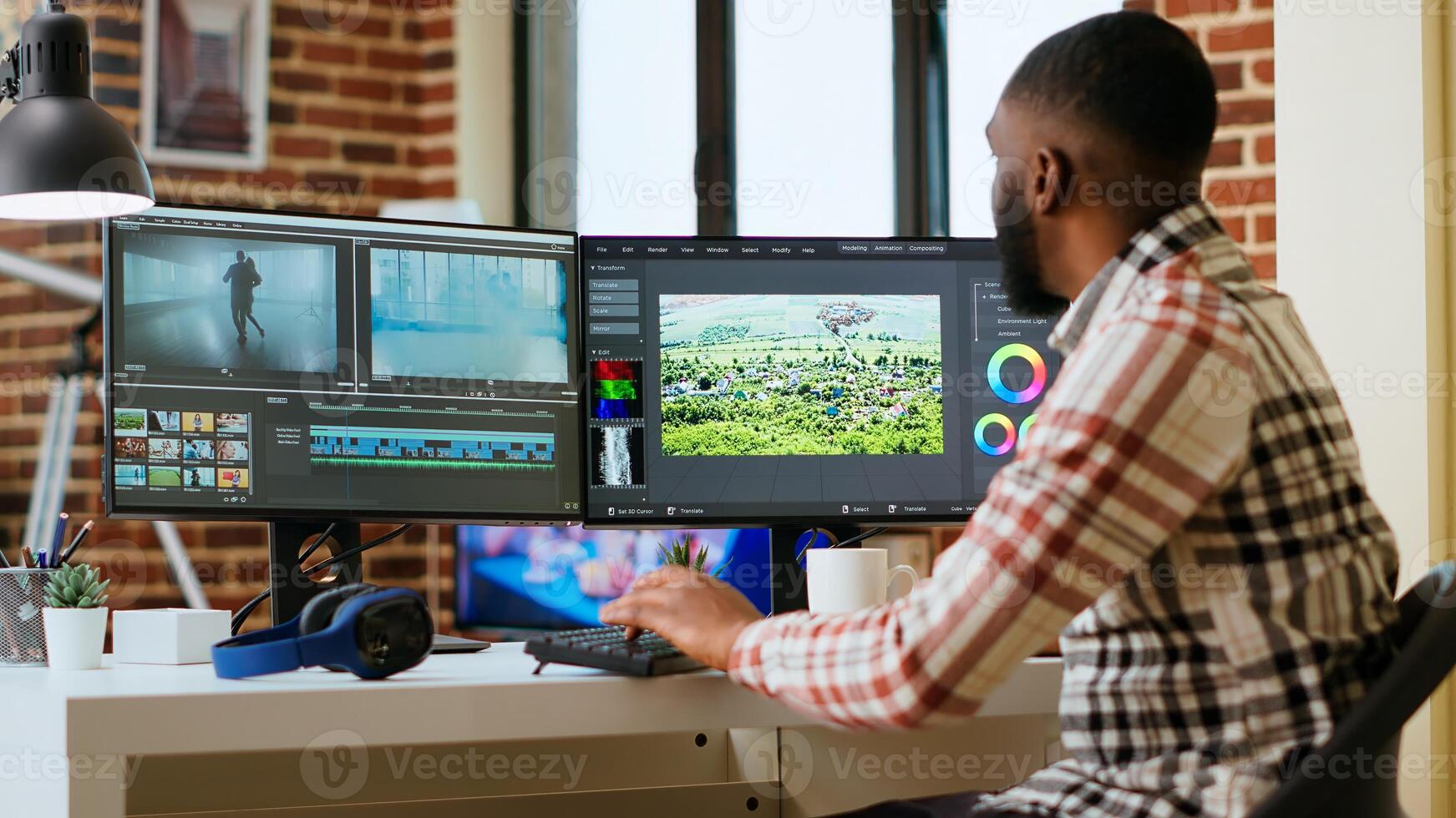 African american man editor working in production industry, does color grading and editing a film project on dual monitors. Showing the creative process with tech tools. Camera B. photo