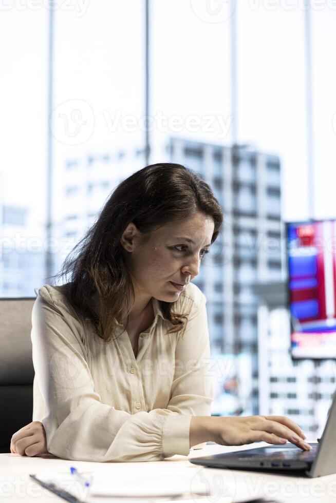 Ambitious focused entrepreneur examines enterprise performance metrics, using data driven analytics and reports to make the right decisions that guarantee efficiency and work ethic. photo