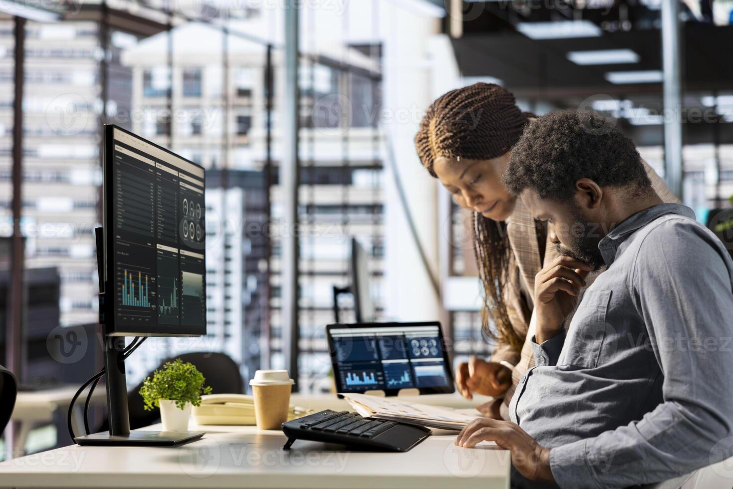 African american CEO and employee review company numbers, creating a roadmap that includes goals, strategies and resource allocation management. Specialists meet corporate objectives. photo