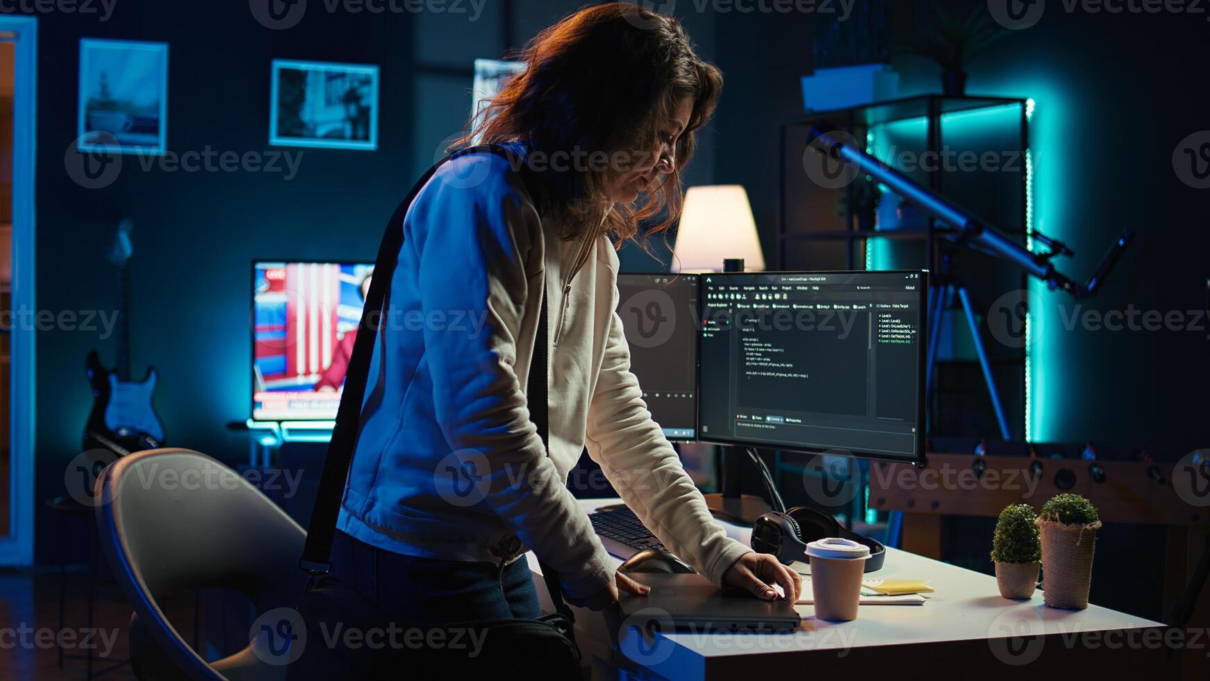 Developer holding disposable cup of coffee entering office to implement security measures, protecting company systems and data. IT worker starting job shift, testing and debugging code, camera B photo