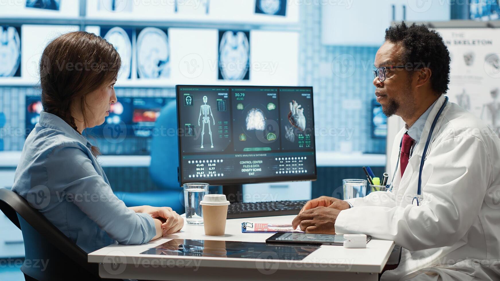 Doctor reading x ray imaging for a diagnostic report at consultation, discussing with a patient about medicine. Physician examining lab test results and analysis, health insurance. Camera A. photo