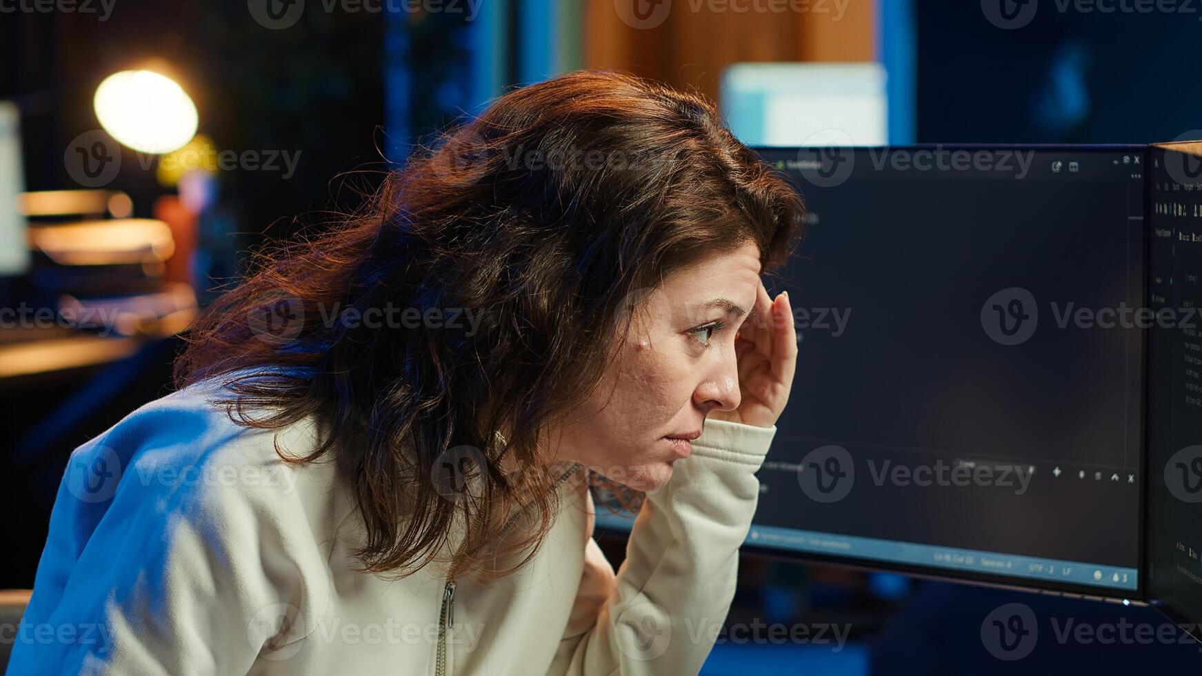 Cybersecurity specialist looking confused at computer screen while trying to fix broken code. Contemplative developer feeling worried and anxious about programming errors, camera A photo