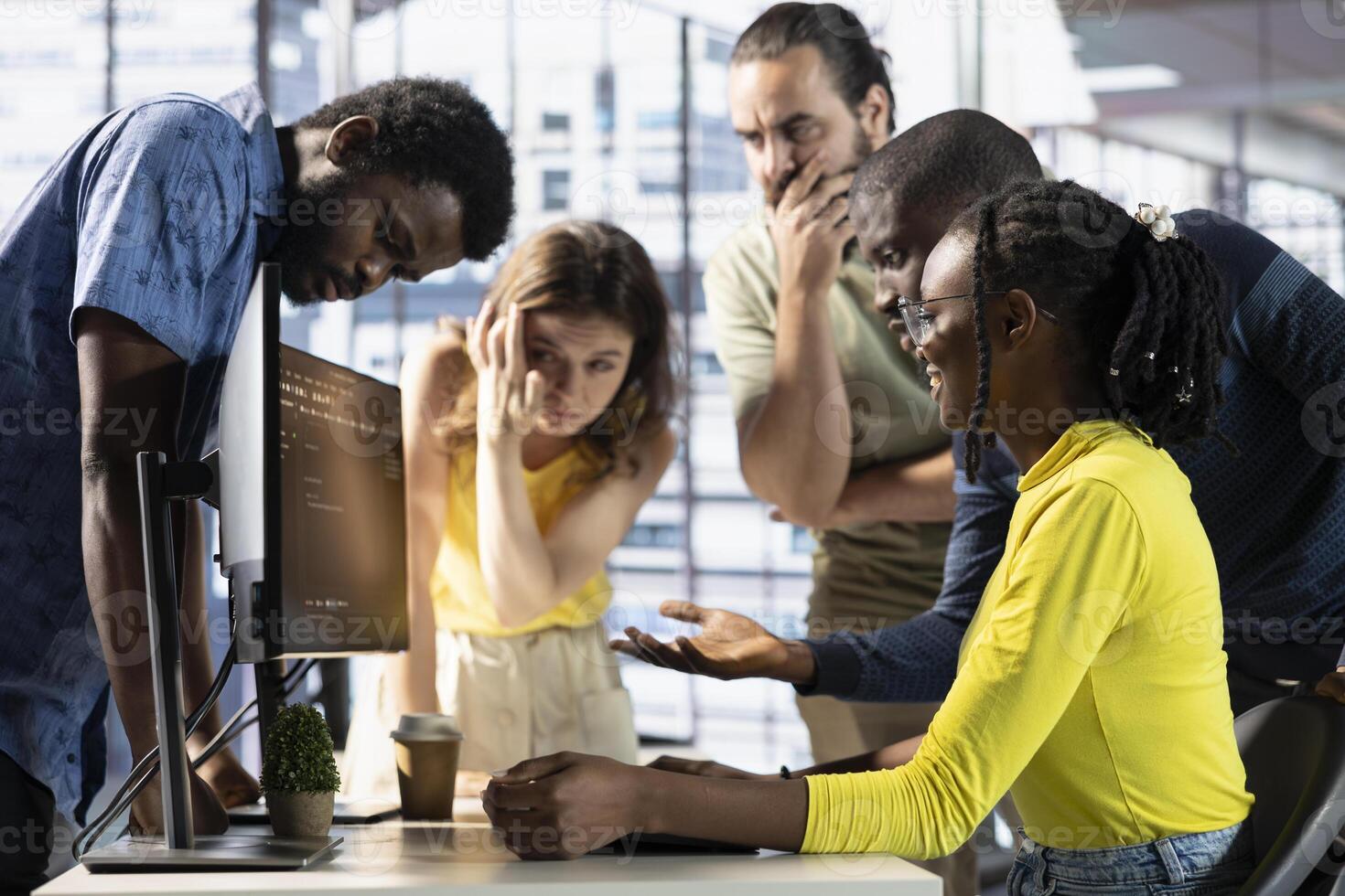 IT staff members discussing and working, testing and deploying programs and systems. Team of software engineers checking code, sitting at desk chair in office, doing brainstorming photo