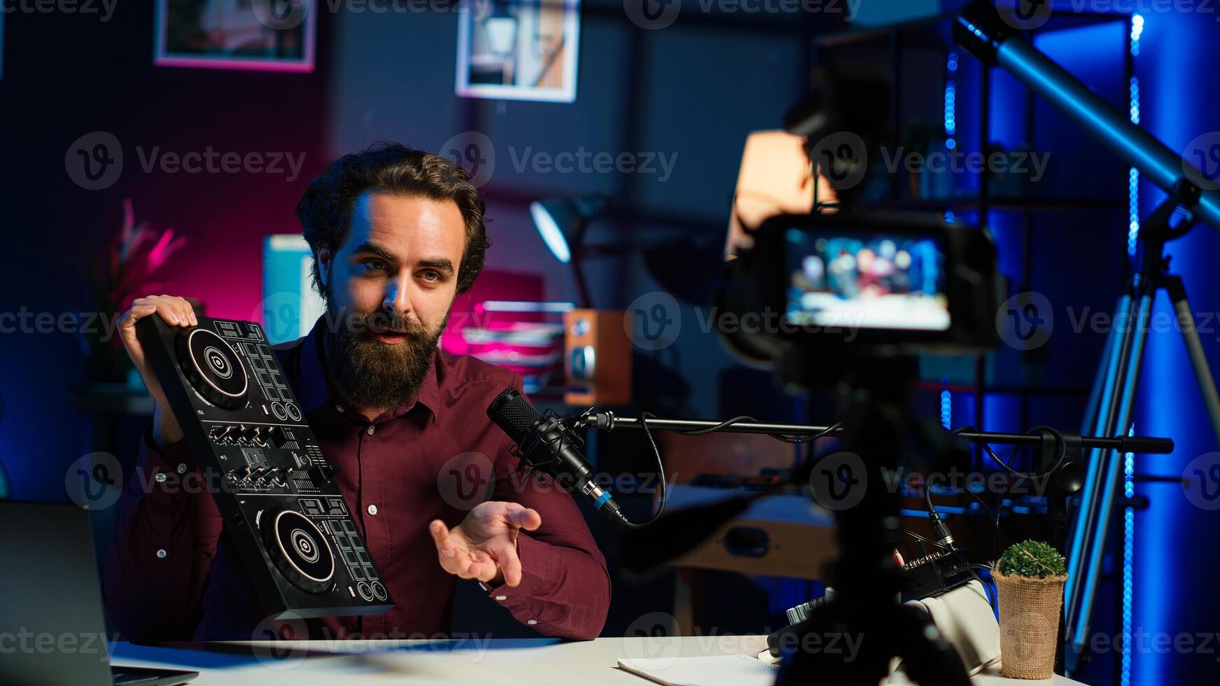 Content creator filming technology review of newly released DJ controller, unboxing it, excited to look at specifications. Influencer showcasing sound mixer device to viewers, camera A photo