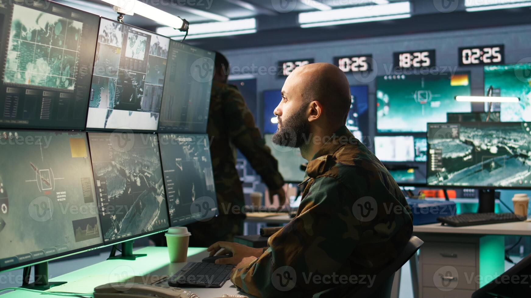 Man looking at screens in military HQ base housing operational missile defense system designed to intercept ballistic rockets. Special forces expert using tracking gear and radar systems, camera B photo