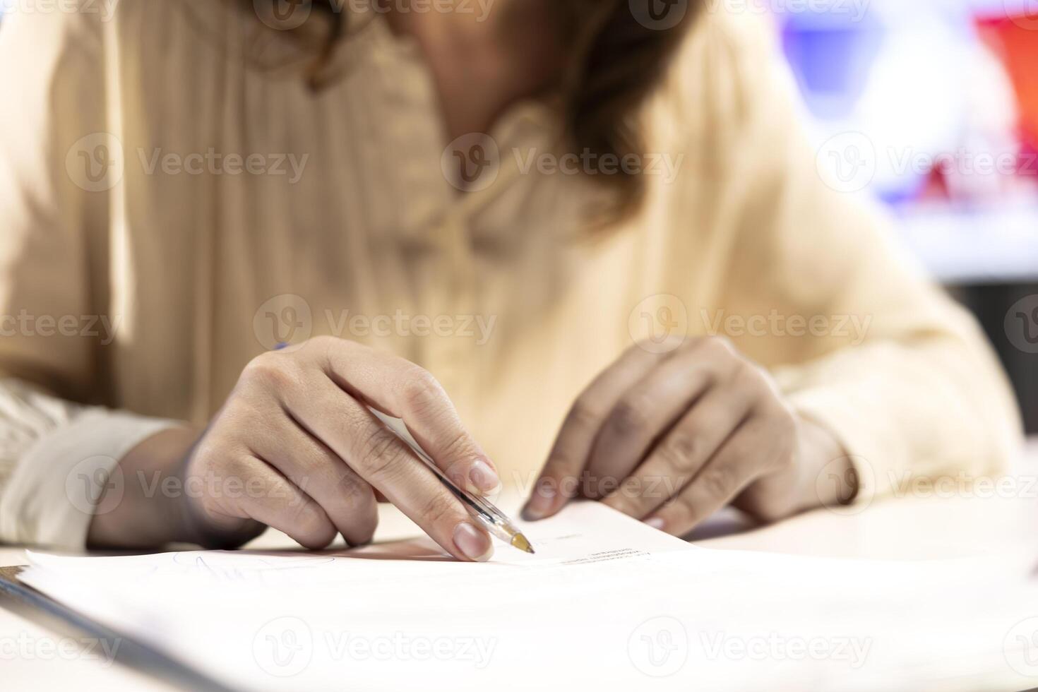 Female CEO solving her business paperwork tasks and signing documents, approving requests from employees and authorizing work contracts in her high end office. Legal management. Close up. photo