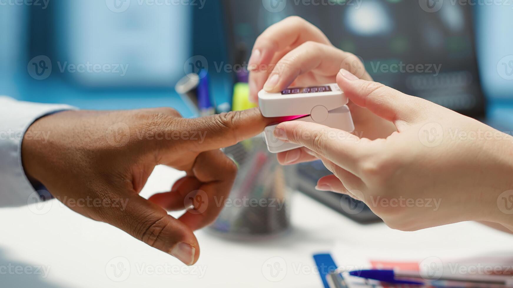 Physician measuring the oxygen saturation and pulse rate using an oximeter during check up visit, consulting her patient with modern medical equipment. Vital signs measurement. Camera A. photo