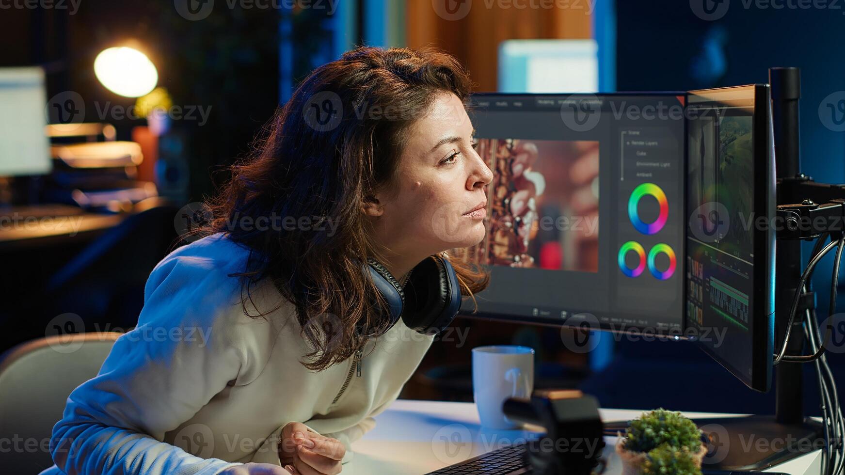 Happy videographer using professional software to create visual effects for projects, proud of results. Smiling expert using post production techniques to edit raw clips footage, camera A photo