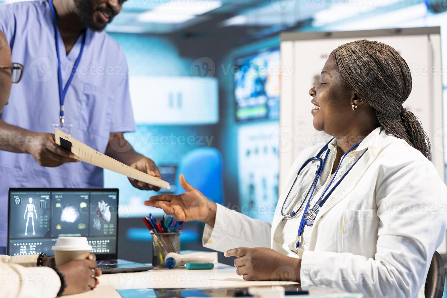 Health specialist advising a young patient during a clinic checkup visit, combining radiology results and tech tools to ensure precise medical analysis and treatment strategies. Expertise. photo