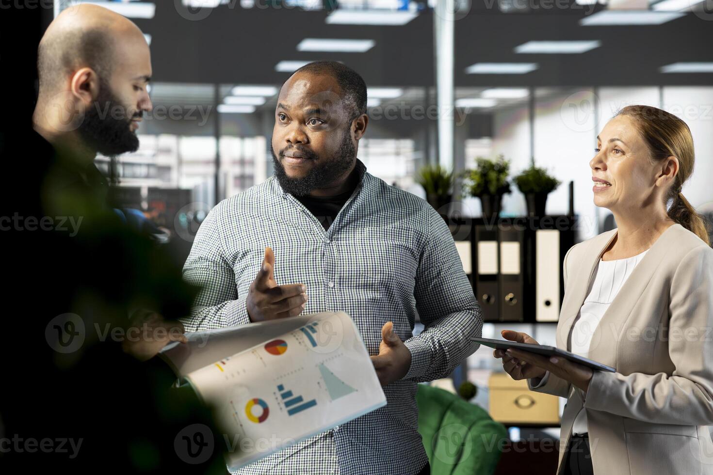 Happy business managers attending briefing meeting with CEO to share new ideas for profit growth. Cheerful specialists talking to director to explain startup evolution vision. photo