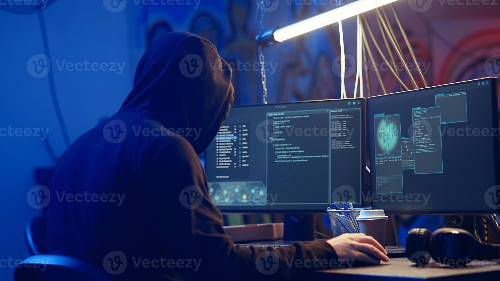 Hooded hacker creating pirating crack for software and game releases in bunker. Rogue programmer getting past anti tamper measures implemented by companies to protect their products, camera A photo